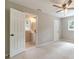 Spacious carpeted bedroom featuring neutral paint and adjoining bathroom at 703 Alvis Ln, Norcross, GA 30093