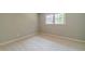 Bright bedroom features neutral walls, plush carpeting, and a window for natural light at 703 Alvis Ln, Norcross, GA 30093
