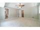 Spacious bedroom features neutral paint, ceiling fan, and ensuite bathroom access at 703 Alvis Ln, Norcross, GA 30093