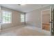 Cozy carpeted bedroom with natural light and access to the other rooms at 703 Alvis Ln, Norcross, GA 30093