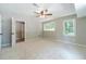 Neutral bedroom with ceiling fan and multiple windows at 703 Alvis Ln, Norcross, GA 30093