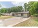 Spacious white brick home with a long driveway and a lush green lawn at 703 Alvis Ln, Norcross, GA 30093
