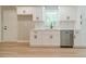 Well-lit kitchen with stainless steel dishwasher and fixtures at 703 Alvis Ln, Norcross, GA 30093