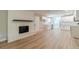 Spacious living room featuring a brick fireplace, open to the modern kitchen at 703 Alvis Ln, Norcross, GA 30093