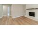 Living room with brick fireplace, light gray walls, and modern flooring at 703 Alvis Ln, Norcross, GA 30093