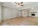Cozy living area with modern flooring, neutral paint, and a charming brick fireplace at 703 Alvis Ln, Norcross, GA 30093