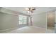 Spacious bedroom with neutral carpeting, large windows, and ample natural light at 703 Alvis Ln, Norcross, GA 30093