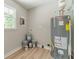 Utility room featuring a hot water tank and window at 703 Alvis Ln, Norcross, GA 30093