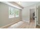 Bright, neutral room with window views and adjacent doorway at 703 Alvis Ln, Norcross, GA 30093