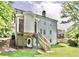 Backyard view of the home with a deck, stairs, and partial basement access at 1300 Winfair Ne Ln, Brookhaven, GA 30329