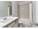 Bathroom with a shower and tub combination featuring a light gray tile surround at 1300 Winfair Ne Ln, Brookhaven, GA 30329