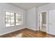 Bedroom featuring hardwood floors, a large window, and an ensuite bathroom at 1300 Winfair Ne Ln, Brookhaven, GA 30329