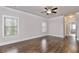 Expansive bedroom featuring hardwood floors, two windows, and a modern ceiling fan at 1300 Winfair Ne Ln, Brookhaven, GA 30329