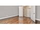 Bedroom features hardwood floors, neutral walls, and a closet door at 1300 Winfair Ne Ln, Brookhaven, GA 30329