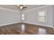 Spacious bedroom with hardwood floors, two windows, and a modern ceiling fan at 1300 Winfair Ne Ln, Brookhaven, GA 30329