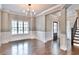 Spacious dining room featuring hardwood floors, wainscoting, and a staircase leading upstairs at 1300 Winfair Ne Ln, Brookhaven, GA 30329