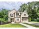 Charming two-story brick home featuring manicured lawn and a convenient two-car garage at 1300 Winfair Ne Ln, Brookhaven, GA 30329