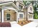 Beautiful two-story home showcasing a well-manicured lawn, brick facade, and covered entrance at 1300 Winfair Ne Ln, Brookhaven, GA 30329