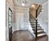 Traditional foyer displaying a stairway with stained treads, white risers, and dark hardwood floors at 1300 Winfair Ne Ln, Brookhaven, GA 30329