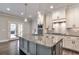 Well-appointed kitchen features a large granite island, stainless appliances, and backyard views at 1300 Winfair Ne Ln, Brookhaven, GA 30329