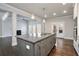 Spacious kitchen island with seating, granite countertops, stainless appliances, and open floor plan at 1300 Winfair Ne Ln, Brookhaven, GA 30329
