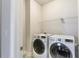 Bright laundry room with modern LG washer and dryer and convenient wire shelving at 1300 Winfair Ne Ln, Brookhaven, GA 30329