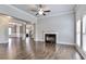 Open-concept living room with fireplace, hardwood floors, and seamless access to adjacent dining and foyer at 1300 Winfair Ne Ln, Brookhaven, GA 30329