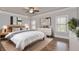 Serene main bedroom featuring hardwood floors, a ceiling fan, and large windows at 1300 Winfair Ne Ln, Brookhaven, GA 30329