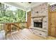 Outdoor patio with a beautiful brick fireplace and wooded views at 1300 Winfair Ne Ln, Brookhaven, GA 30329