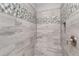 Detailed view of the shower showcasing tile accents, built-in seating, and modern fixtures at 1300 Winfair Ne Ln, Brookhaven, GA 30329