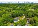 Beautiful aerial view of the neighborhood with expansive green tree canopy and city skyline in the distance at 1317 Bernard Nw St, Atlanta, GA 30314