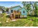 Charming light blue home featuring a wooden deck and staircase leading to a grassy, well-maintained backyard at 1317 Bernard Nw St, Atlanta, GA 30314