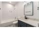 A beautifully renovated bathroom with a tub, white tile and modern fixtures at 1317 Bernard Nw St, Atlanta, GA 30314