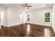 A modern bedroom with dark wood floors, ceiling fan, and natural light at 1317 Bernard Nw St, Atlanta, GA 30314