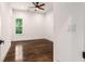 Cozy bedroom with hardwood floors, ceiling fan, and a window with a view at 1317 Bernard Nw St, Atlanta, GA 30314