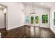 Bright dining room with wooden floors, modern chandelier, and glass doors leading to the deck at 1317 Bernard Nw St, Atlanta, GA 30314