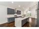 Well-lit modern kitchen with gray cabinets, stainless steel appliances, and marble countertops at 1317 Bernard Nw St, Atlanta, GA 30314
