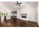 Open-concept living space with hardwood floors, modern light fixture, and fireplace at 1317 Bernard Nw St, Atlanta, GA 30314