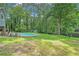 Backyard with a pool, a shed, and mature trees offers a private outdoor oasis at 3392 Inns Brook Way, Snellville, GA 30039