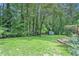 Spacious backyard featuring a shed, mature trees, and a lush lawn at 3392 Inns Brook Way, Snellville, GA 30039
