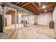 Unfinished basement with exposed wood ceiling and support beams, ready for customization at 3392 Inns Brook Way, Snellville, GA 30039