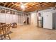 Unfinished basement area with exposed ceiling and a stainless steel refrigerator at 3392 Inns Brook Way, Snellville, GA 30039
