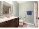 Cozy bathroom featuring a decorative framed mirror, a shower, and wood-look flooring at 3392 Inns Brook Way, Snellville, GA 30039