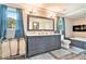 Bathroom with dual vanity, soaking tub and a modern electric fireplace at 3392 Inns Brook Way, Snellville, GA 30039