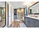 Modern bathroom featuring dual vanity, glass shower and walk-in closet at 3392 Inns Brook Way, Snellville, GA 30039