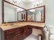 Well-lit bathroom featuring a large vanity with sink and a dual paneled mirror above at 3392 Inns Brook Way, Snellville, GA 30039