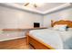 Well-lit bedroom with wood trim featuring a queen bed and long desk setup at 3392 Inns Brook Way, Snellville, GA 30039