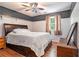 Charming bedroom with decorative walls, a queen bed, wood floors and matching night stand at 3392 Inns Brook Way, Snellville, GA 30039