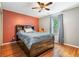 Cozy bedroom featuring a queen bed, wood floors, and large window at 3392 Inns Brook Way, Snellville, GA 30039