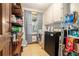 Laundry room and pantry with washing machine and dryer next to wooden shelves at 3392 Inns Brook Way, Snellville, GA 30039